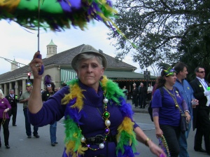 A woman dancing with her umbrella on top of her head in a pre-carnival parade in the FrenchQuarter . Wadner Pierre